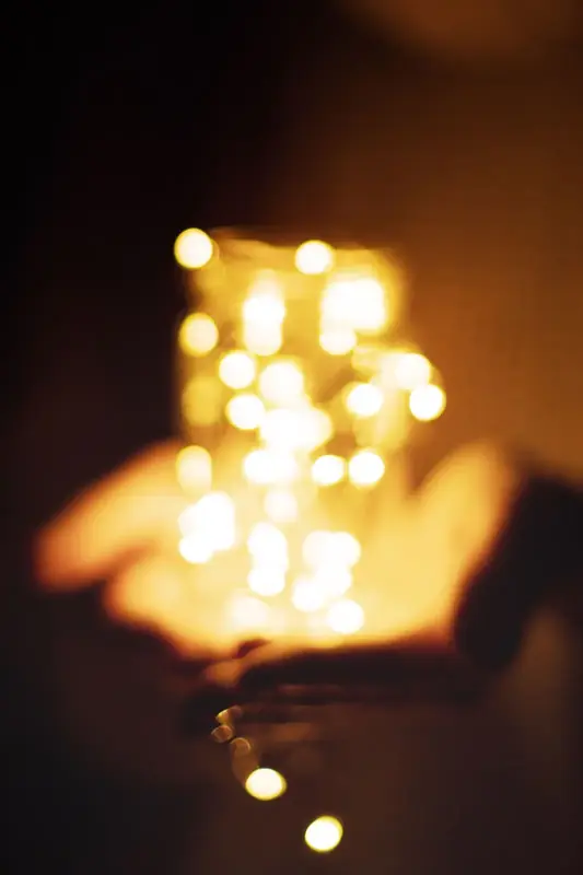 Hands holding a bundle of warm fairy lights