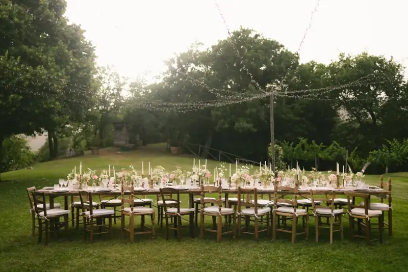 Wedding table on a lawn under string lights